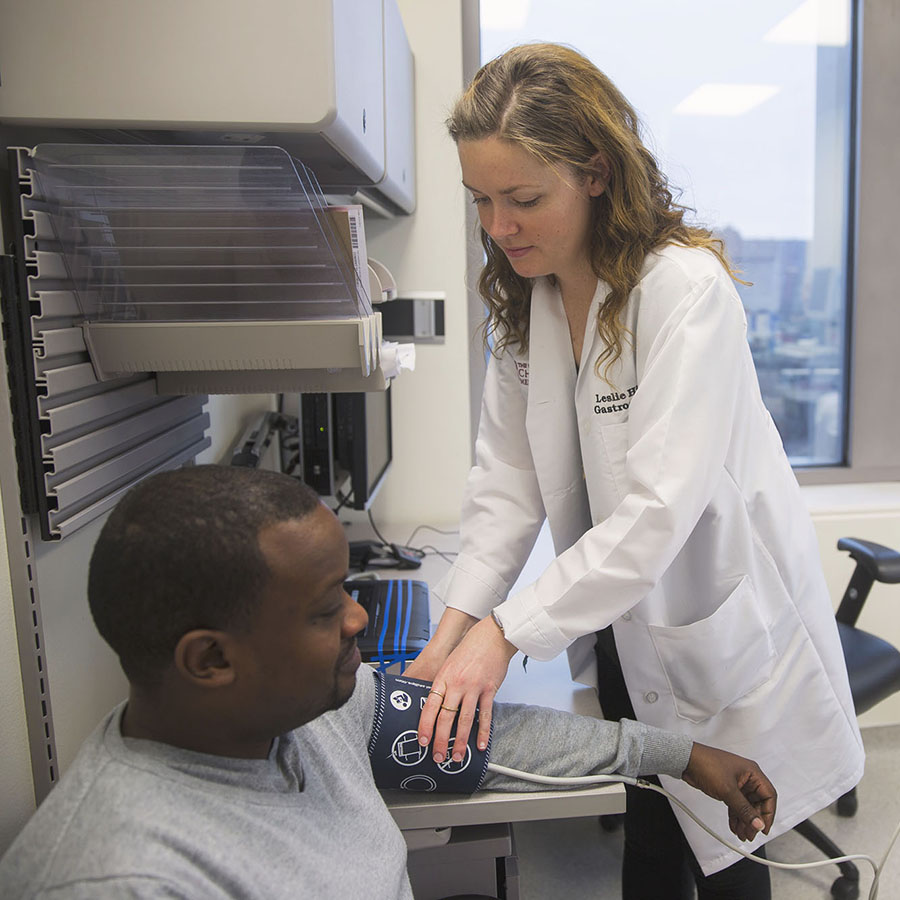 doctor checking patients blood pressure