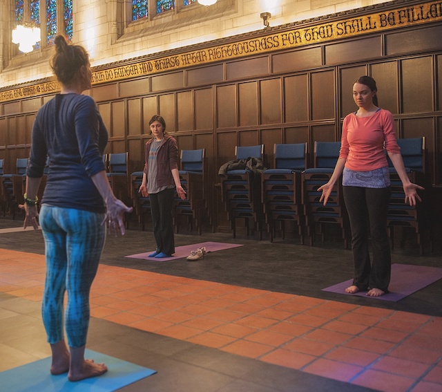 people doing yoga in a chapel