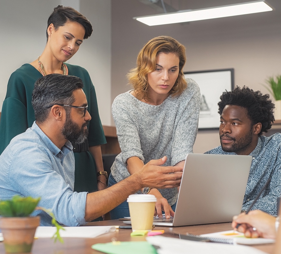 group of people gathered around a computer