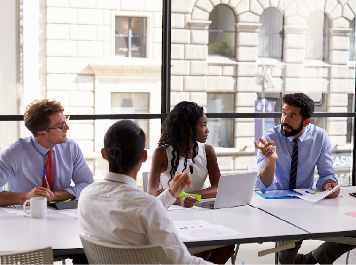 Students having a meeting in a classroom.