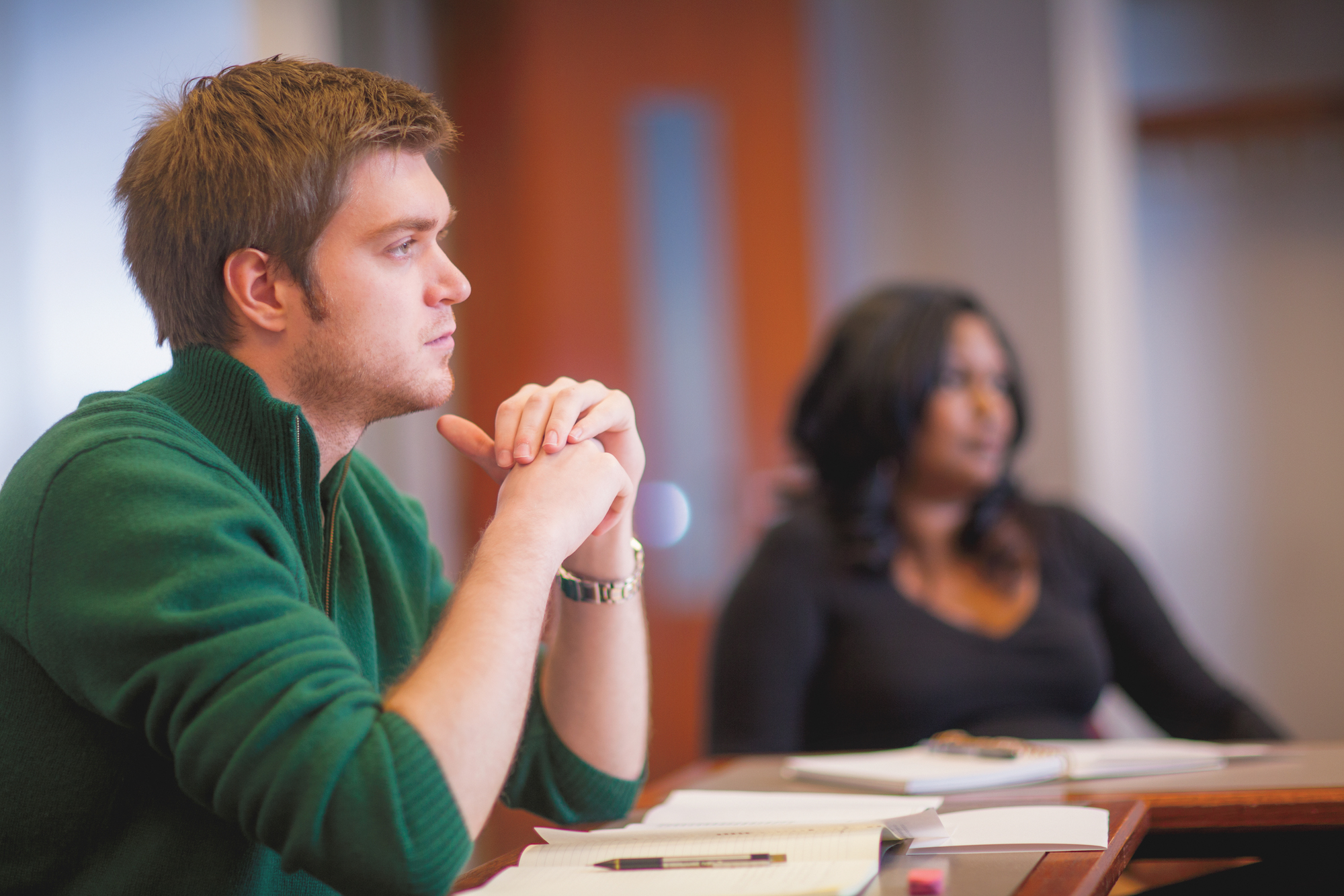 Two students listening during a class lecture.
