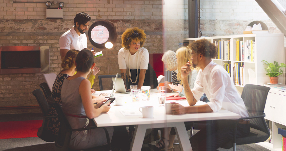 A group of people have a meeting in an office space.