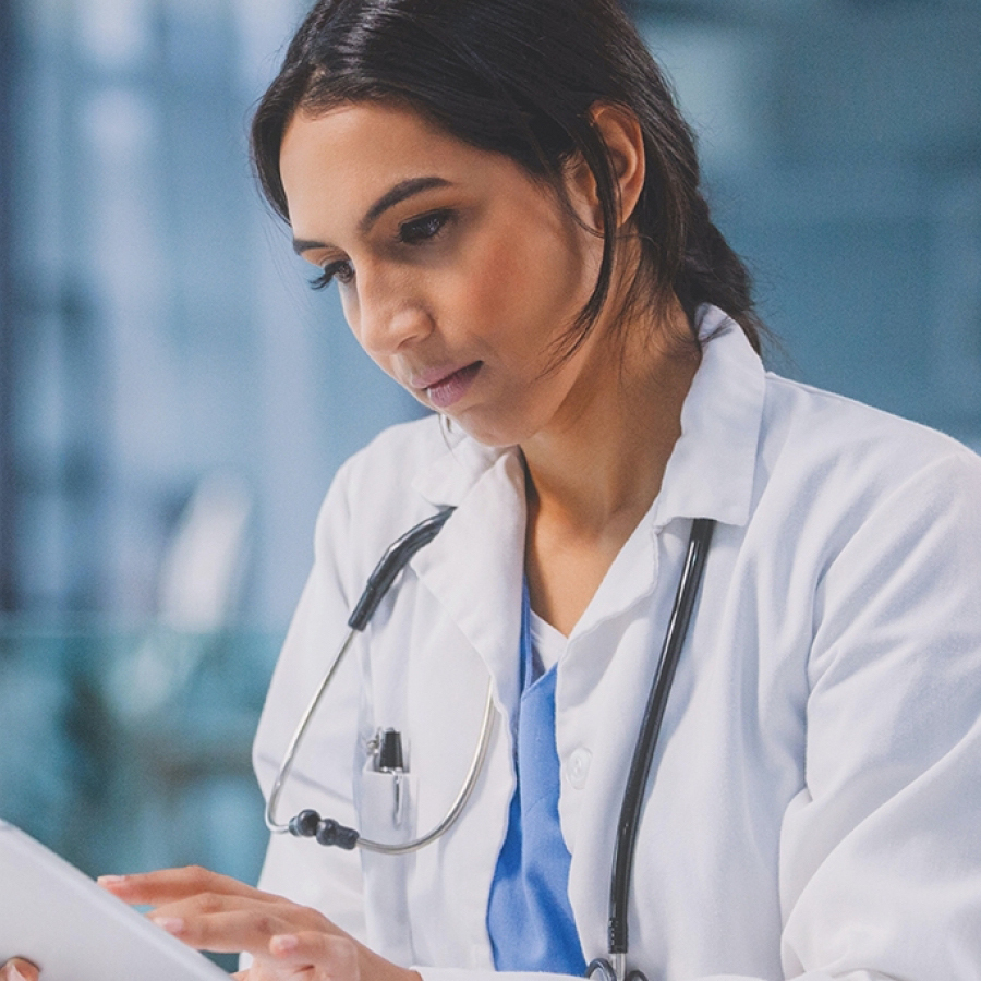 doctor looking at a tablet.