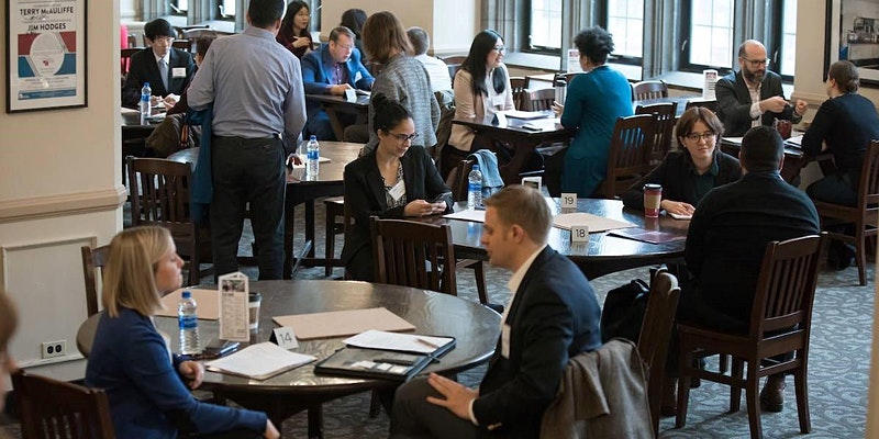 A group of people attend a networking event.