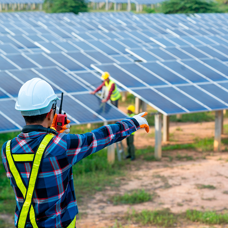 Workers adjust solar panels