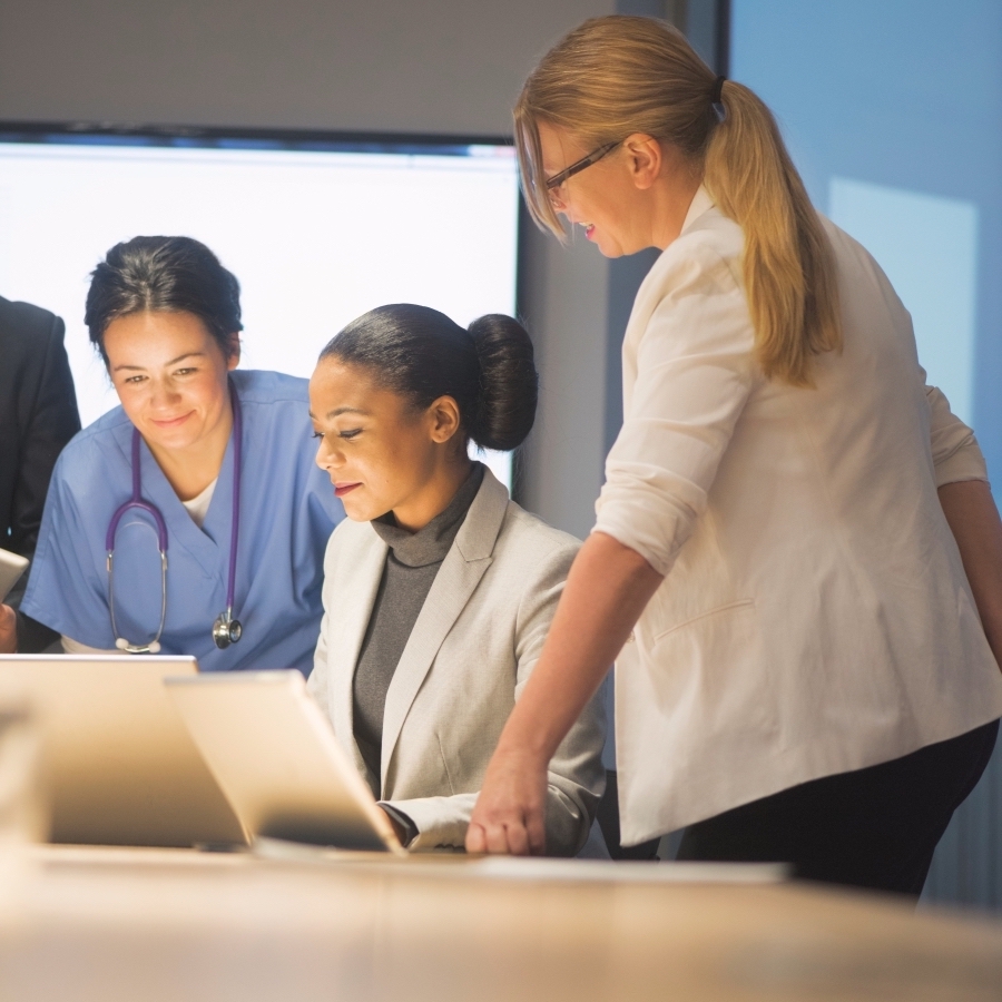 Medical professionals discussing work in a meeting.