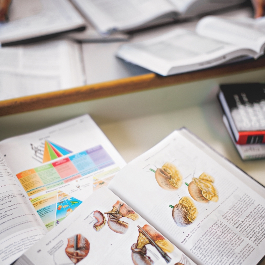 A table displaying open medical books.