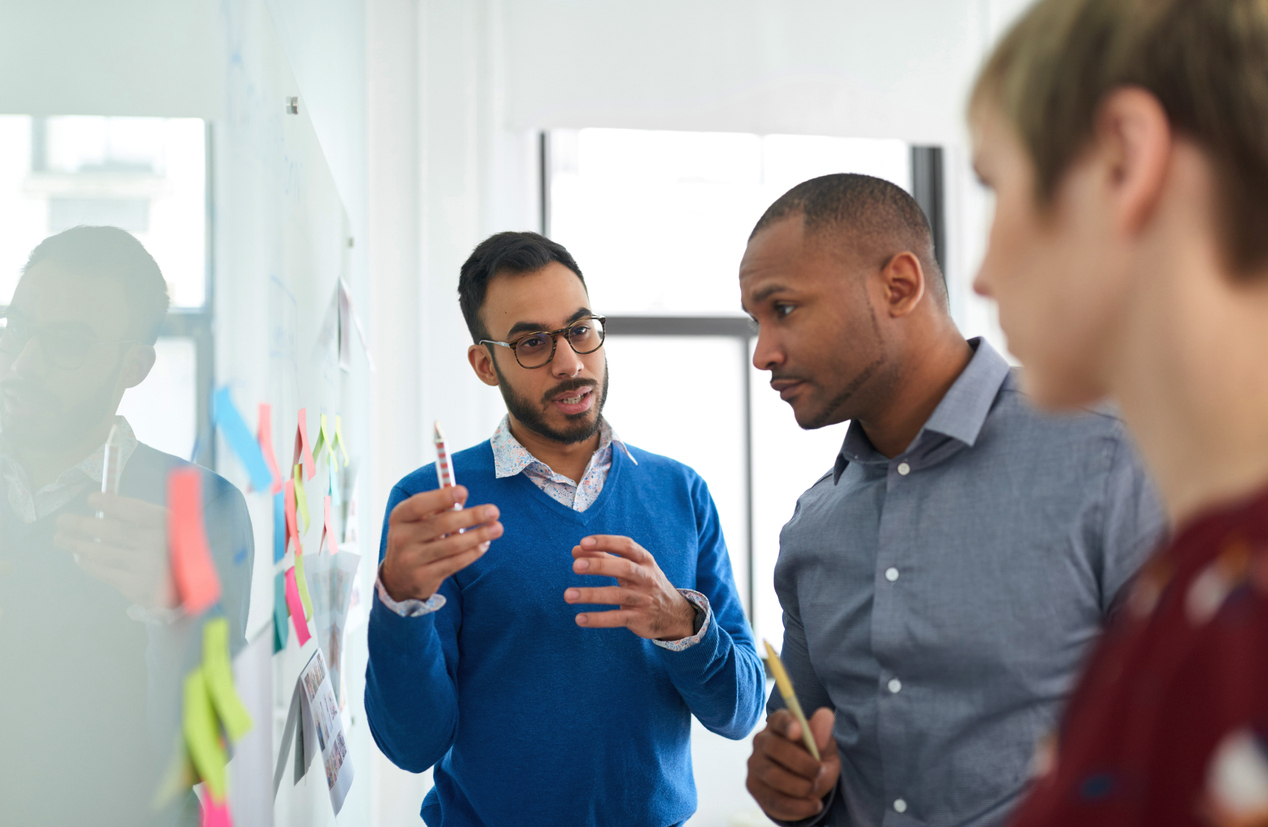 Diverse team of coworkers brainstorming strategies together.