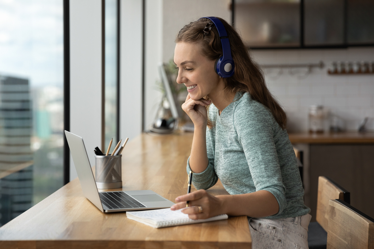 Smiling woman holding a video call conversation.