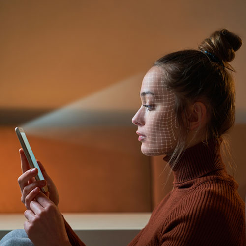 A phone scanning a woman's face id.