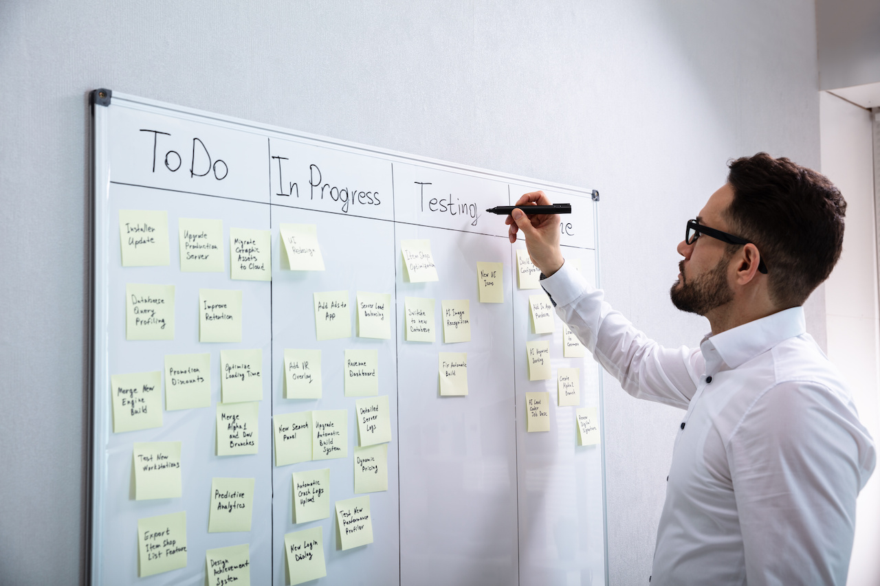 A project management professional creating a workflow on a board.