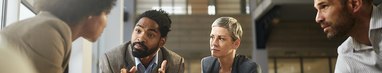 people sitting around a table having a discussion