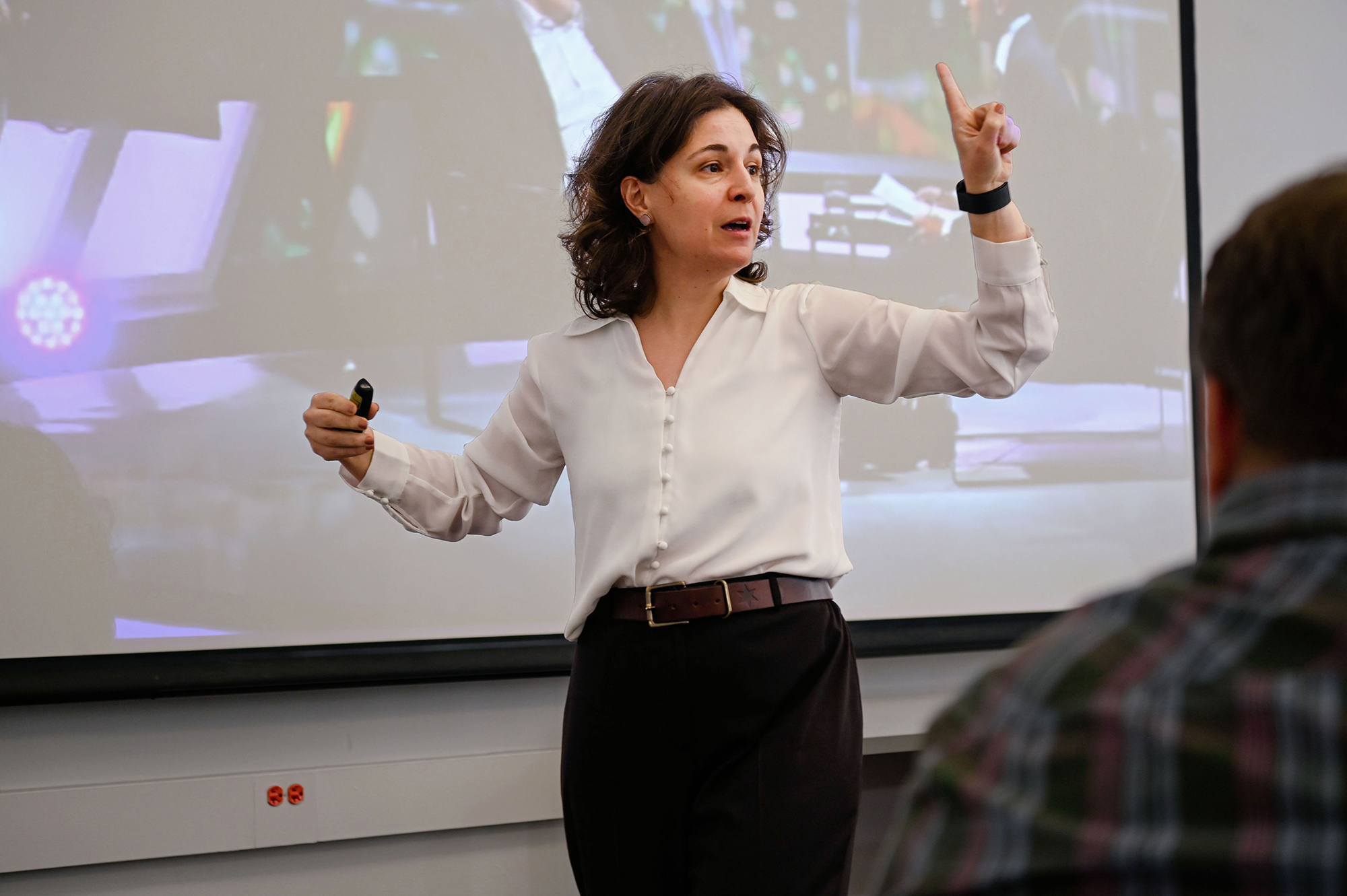 Instructor teaching in front of a screen