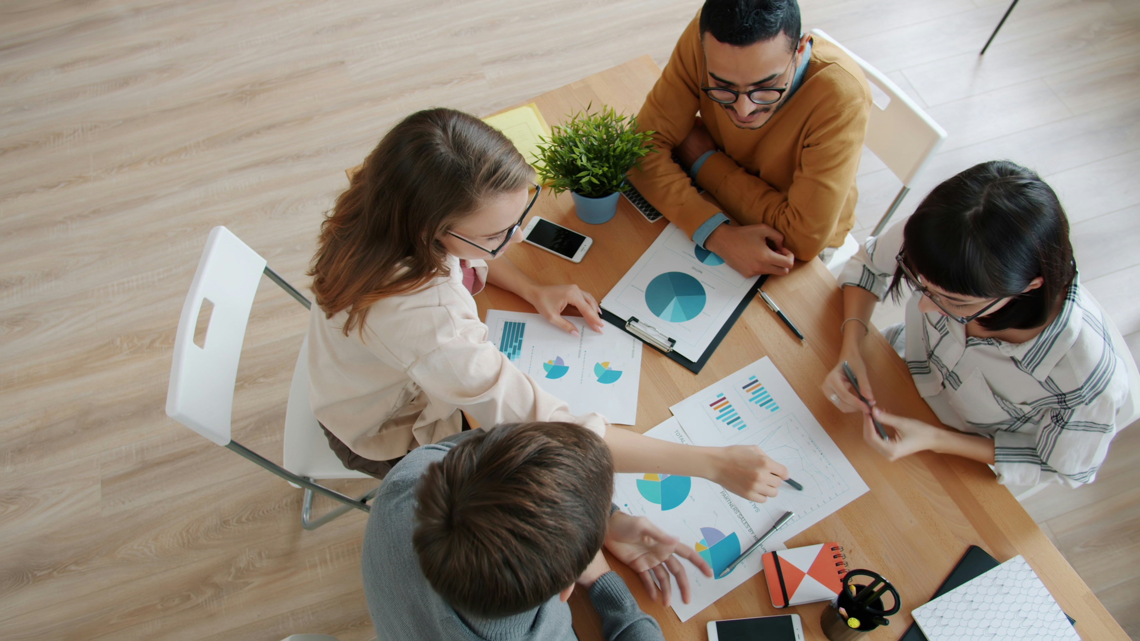 People working around a table and looking at data