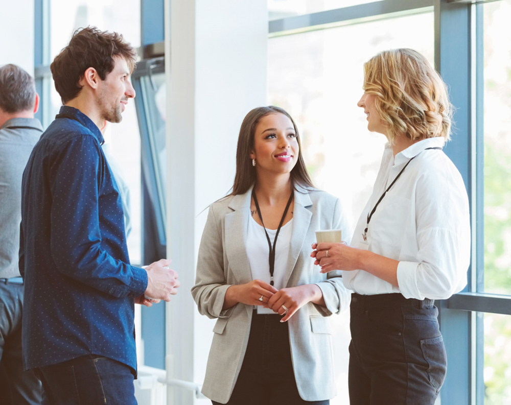 A group of people standing and speaking