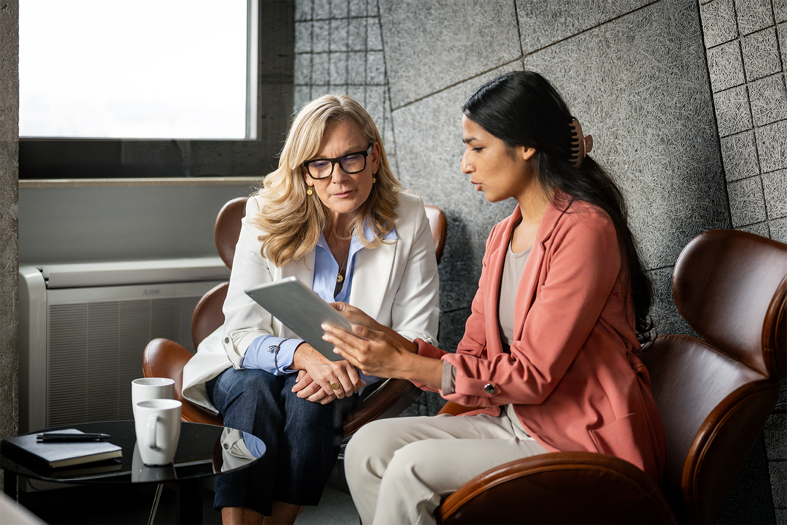 An older woman coaching a younger woman
