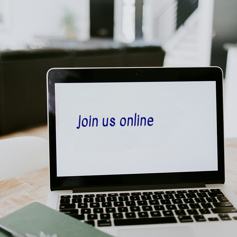 An open laptop sitting on a desk with the words "join us online" on the screen