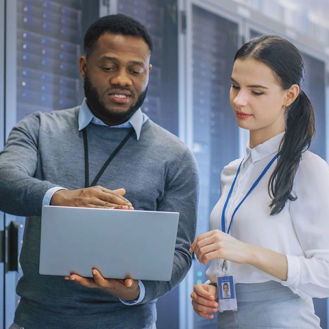 picture of a man and a woman looking at a laptop