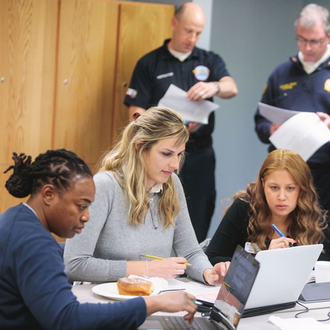 Three students working together on laptops