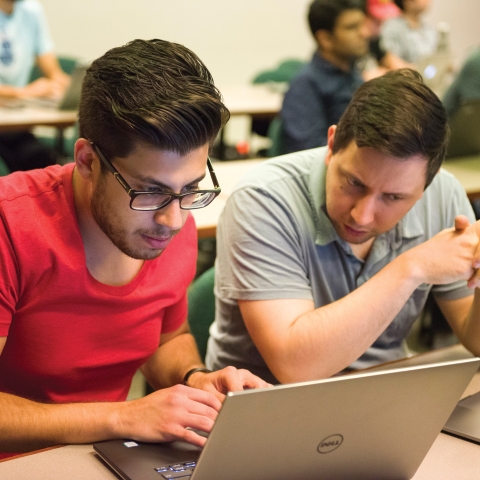 Students in classroom working on laptop