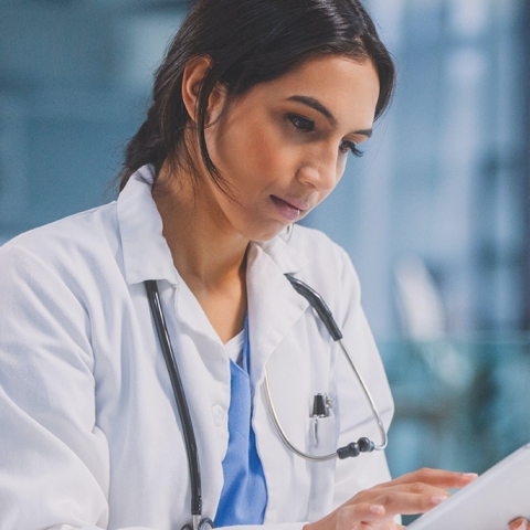 doctor looking at a tablet