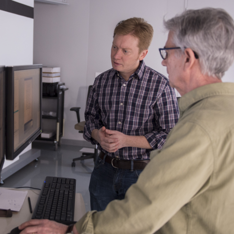 two men looking at a computer screen