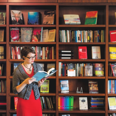 A student peruses a book at the University of Chicago Press