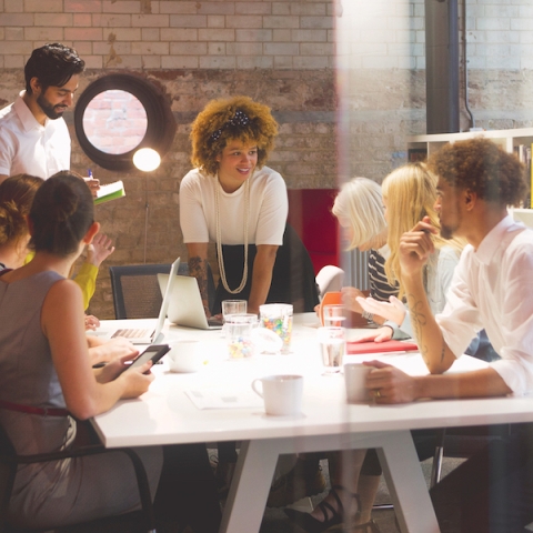 A group of people have a meeting in an office space.
