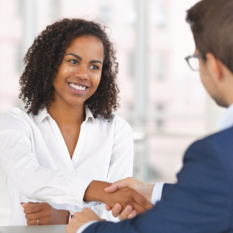 Two people shaking hands in agreement.