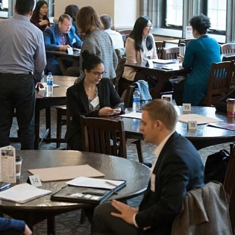 A group of people attend a networking event.