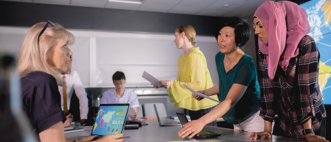 group of people looking at a map