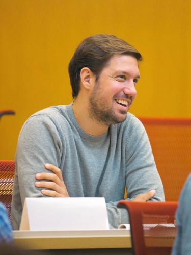 Certificate student sitting at desk and smiling.