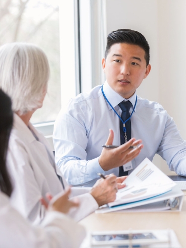 Doctors in conference room talking