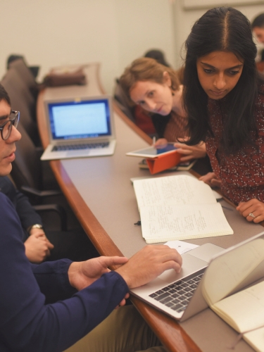 Students looking at laptop