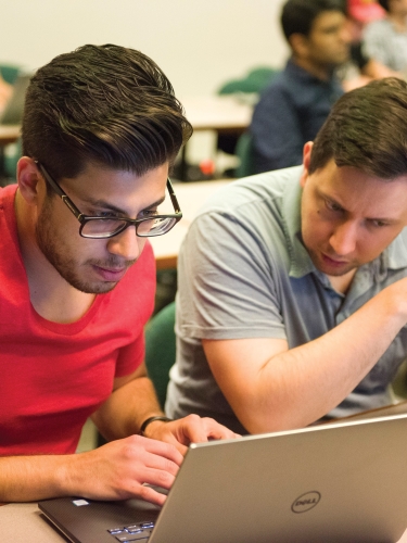 Students in classroom working on laptop