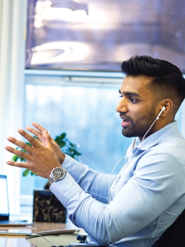 Man sitting at desk talking