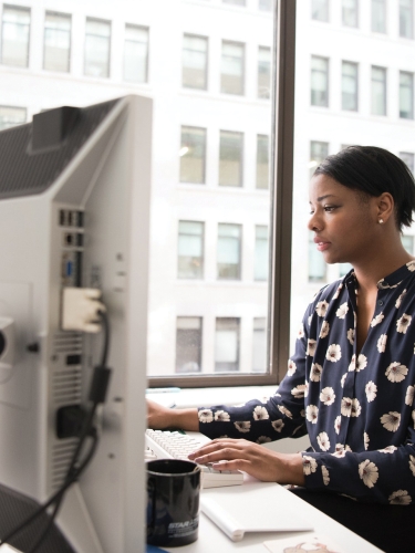 Woman at desk workin on a computer