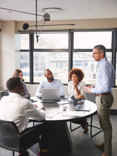 A group of business professionals having a meeting in a conference room.