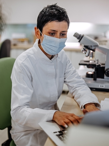 Scientist looks through documents at a lab.