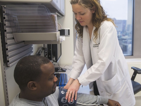 doctor checking patients blood pressure