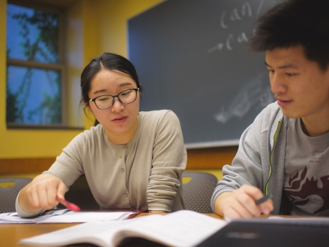 Two students working together at a desk