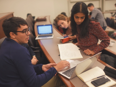 Students looking at laptop