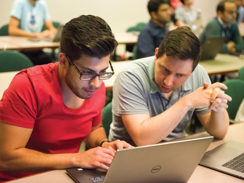 Students in classroom working on laptop