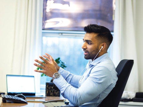 Man sitting at desk talking