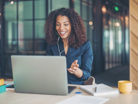 Woman with headphones in at computer