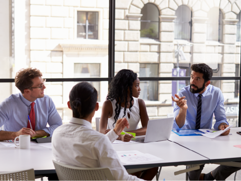 Students having a meeting in a classroom.