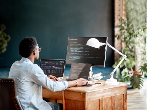 A student looking at coding on a monitor.