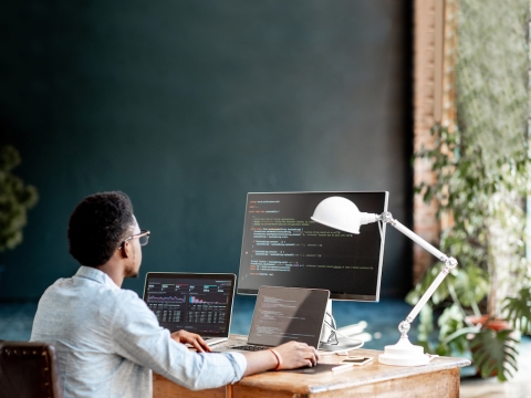 A student looking at coding on a monitor.