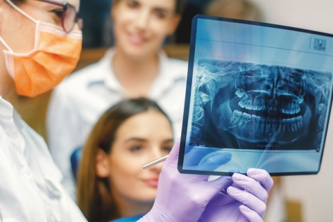 Dentist showing an x-ray result.