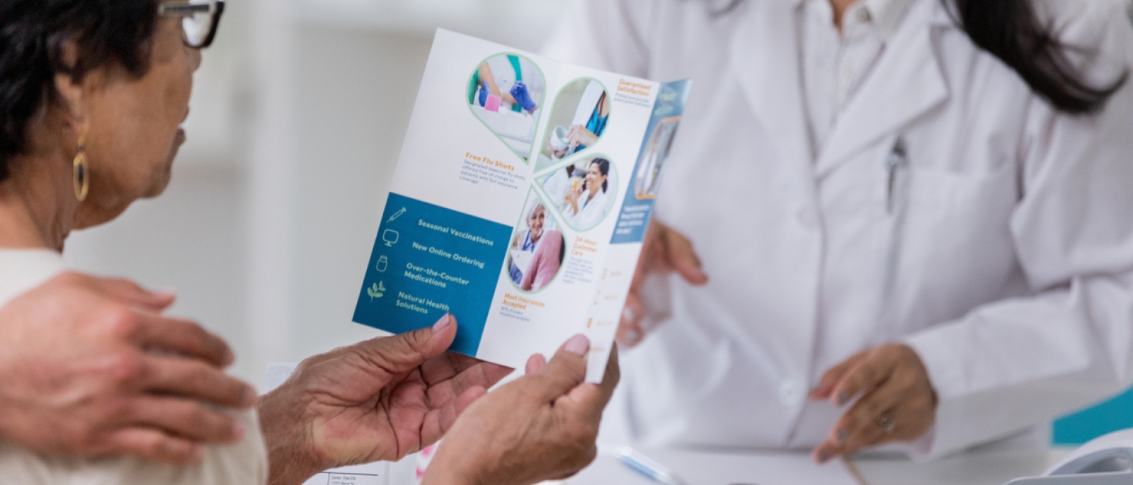 Senior woman examines pharmacy brochure.